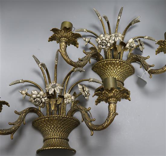 A pair of wall sconces designed as baskets of flowers